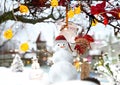 Christmas snow man in red santa hat and holiday  trees decoration on street Tallinn Old town  snowy weather travel to Estonia Euro Royalty Free Stock Photo