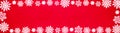 Christmas snow winter background banner panorama - Frame made of snow with snowflakes and ice crystals on red texture, top view Royalty Free Stock Photo