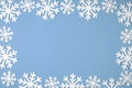 Christmas snowflake border frame on blue background. Xmas minimal texture with copy space. top view Royalty Free Stock Photo