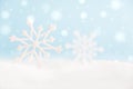 Christmas snowflakes on surface with snow and defocused lights with copy space Royalty Free Stock Photo