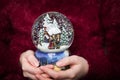 Christmas snowglobe in hands