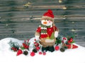 Christmas snowman decoration winter berries and snow on wooden b Royalty Free Stock Photo
