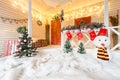 Christmas snowman and decoration on wood. on the terrace bright with garlands Royalty Free Stock Photo