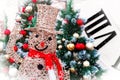 A Christmas snowman made of gold wire in a top hat and a red knitted scarf Royalty Free Stock Photo