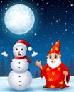 Christmas snowman with red old wizard in the winter night background Royalty Free Stock Photo