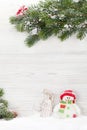 Christmas snowman and sledge toys and fir tree branch Royalty Free Stock Photo