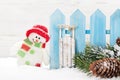 Christmas snowman and sledge toys and fir tree branch Royalty Free Stock Photo