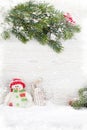 Christmas snowman and sledge toys and fir tree branch Royalty Free Stock Photo