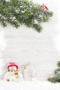 Christmas snowman and sledge toys and fir tree branch Royalty Free Stock Photo