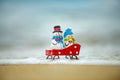 Christmas snowman on summer sea background. Tropical paradise, ocean beach texture for new year banner. Royalty Free Stock Photo