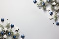 Christmas snowy border of shiny balls and classic blue stars, evergreen branches on neutral pastel grey background Royalty Free Stock Photo