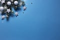 Christmas snowy border of shiny balls and stars, evergreen branches on blue background. New Year card Royalty Free Stock Photo