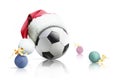 Christmas soccer. Soccer ball in santa hat Christmas toys on a white background. Isolated