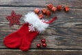 Christmas sock with fur edge, gifts, snowflakes and balls on wooden table Royalty Free Stock Photo