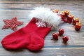 Christmas sock with fur edge, gifts, snowflakes and balls on wooden table