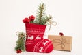 Christmas sock with gifts. Christmas card. New Year`s composition. Christmas gifts, pine branches, toys