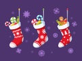 Christmas Socks with Cute Ornaments and Sweet Gifts. Stockings with Candy Canes, Lollipops and Gingerbread Bakery