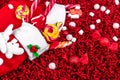 Christmas socks full of candy and sweets on red fleecy background. Flat lay. Copy space. Royalty Free Stock Photo