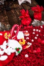 Christmas socks full of candy and sweets on red fleecy background. Flat lay. Copy space. Royalty Free Stock Photo