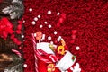 Christmas socks full of candy and sweets on red fleecy background. Flat lay. Copy space. Royalty Free Stock Photo