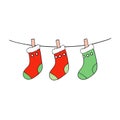 Christmas socks hanging on a clothesline iolated on white background Royalty Free Stock Photo