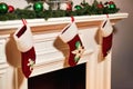 Christmas socks hanging on fireplace in room interior Royalty Free Stock Photo