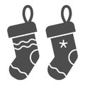 Christmas socks solid icon. Two stuffer socks vector illustration isolated on white. Christmas stocking glyph style Royalty Free Stock Photo