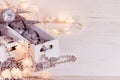 Christmas soft silver apples and lights burning in boxes on a wooden white background. Royalty Free Stock Photo