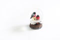 Christmas souvenir - bullfinch in glass ball with snow. A pair of birds with a red belly on a birdhouse in a flask of snow. New ye