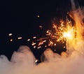 Christmas sparkler fire in dense smoke, dark background Royalty Free Stock Photo