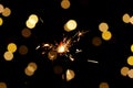 Christmas sparkler Isolated On Black background with Christmas Lights Defocused Bokeh