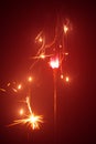 Christmas sparkler with red light Royalty Free Stock Photo