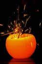 Christmas sparklers is ignited from candle flame. Sparks bursting in the air. Royalty Free Stock Photo