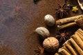 Christmas composition with cinnamon sticks; anise stars, nutmeg, cloves and hazelnut on dark background. Copy space for your text. Royalty Free Stock Photo