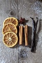 Christmas spices, dried orange slices, cinnamon sticks, star anise, vanilla beans on wooden background Royalty Free Stock Photo