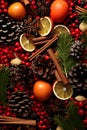 Christmas spices, fruit pieces, baubles, seeds and leaves abstract background.