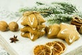 Christmas spices, gingerbread cookies and baking ingredients on white background. Cinnamon, anise stars, wallnuts, cloves for