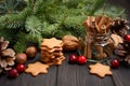 Christmas Spices, Gingerbread Cookies and Nuts. Holiday concept decorated with Fir branches and Cranberries. Royalty Free Stock Photo