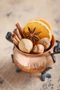 Christmas spices, nuts and dried oranges on a wooden background. Royalty Free Stock Photo