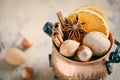 Christmas spices, nuts and dried oranges on a wooden background. Royalty Free Stock Photo