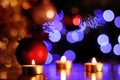 Christmas Traditional spirit with golden candles and sparkling lights in background