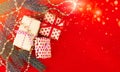 Christmas spruce (fir) branch, gift boxes e.t.c on red background Royalty Free Stock Photo