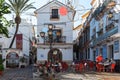 Christmas square with small cafe among narrow streets of sunny town Marbella, Andalusia, Spain