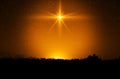 Christmas star. Background of the beautiful nite golden starry sky and bright star. Royalty Free Stock Photo