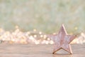 Christmas star, decor on bokeh colored background. Christmas or New Year minimal concept