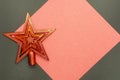 Christmas star decoration on a red and gray background with copy space Royalty Free Stock Photo