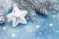 Christmas star with glass ball, firtree branch with cone on blue Royalty Free Stock Photo