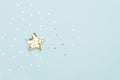 Christmas star made with mold for the cookies and gold sparkling stars on blue background. Flat lay. Christmas concept Royalty Free Stock Photo