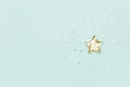 Christmas star made with mold for the cookies and gold sparkling stars on blue background. Flat lay. Holidays Royalty Free Stock Photo
