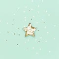 Christmas star made with mold for the cookies and gold sparkling stars on blue background. Flat lay. Holidays and Christmas Royalty Free Stock Photo